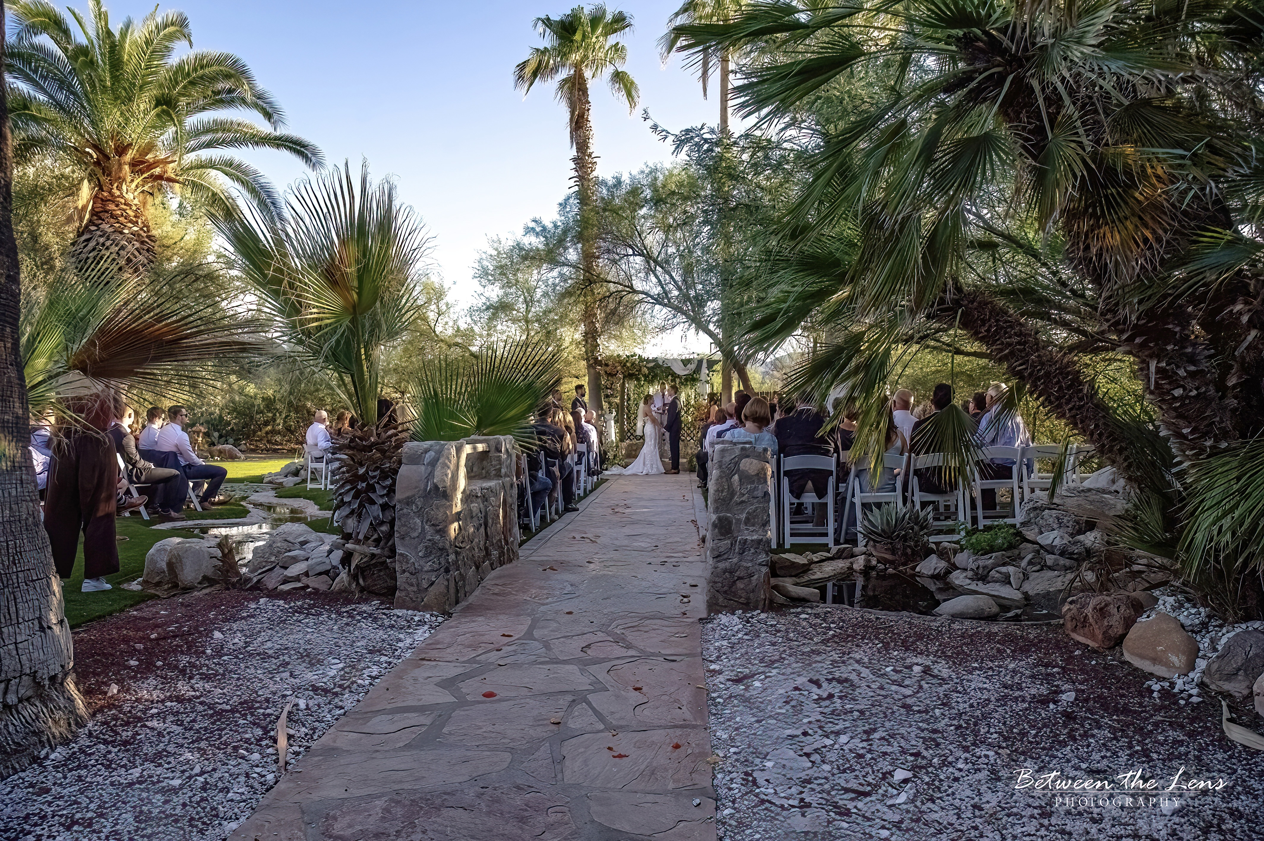 Couple during ceremony, viewed down the aisle